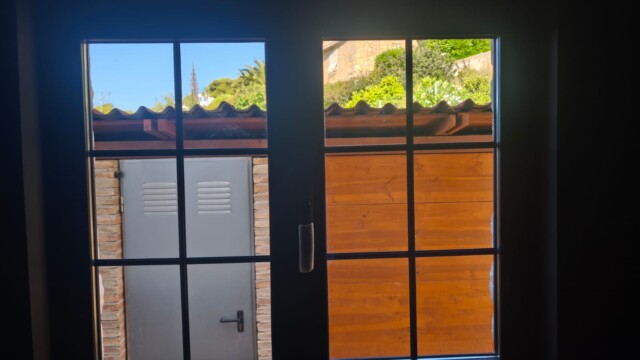 Installation of titanium solar window film in Benissa Alicante. Views from interior and exterior after installation