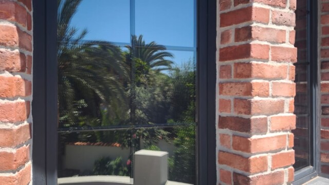 Installation of titanium solar window film in Benissa Alicante. Views from interior and exterior after installation